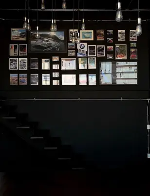 a display case in a room with photos on the wall at The LOCAL Ari in Bangkok