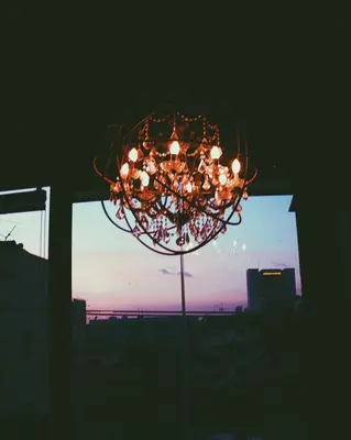 a chandelier with lights in front of a window at The LOCAL Ari in Bangkok