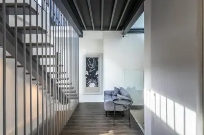 a hallway with a spiral staircase in a house at UHU Bangkok in Bangkok