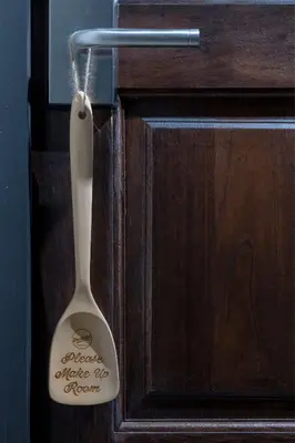 a wooden door with a spoon hanging from it at FOODOTEL in Bangkok