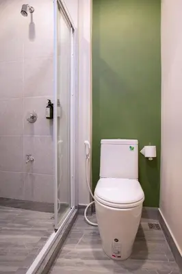a bathroom with a toilet and a shower at FOODOTEL in Bangkok