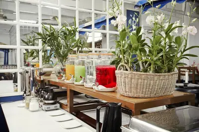 a table with some plants on top of it at The Krungkasem Srikrung Hotel in Bangkok
