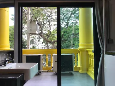 a bathroom with a sink and a yellow wall at S1hostel Bangkok in Bangkok