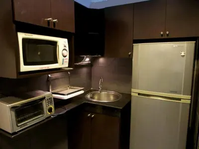 a small kitchen with a microwave and a sink at S1hostel Bangkok in Bangkok