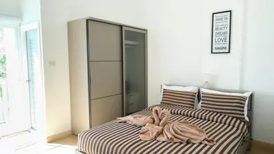 a bedroom with a bed with two animals on it at The Square 101 in Bangkok