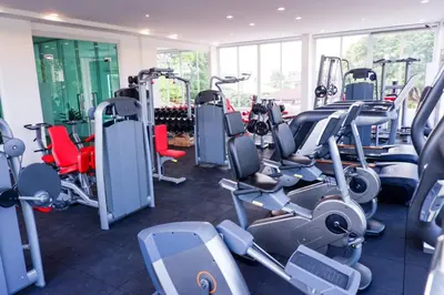 a gym with lots of treadmills and machines at The Square 101 in Bangkok