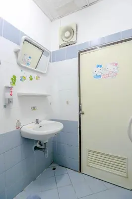 a bathroom with a sink and a toilet and a door at OYO 525 MRT Phetkasem 48 -1 Place in Bangkok