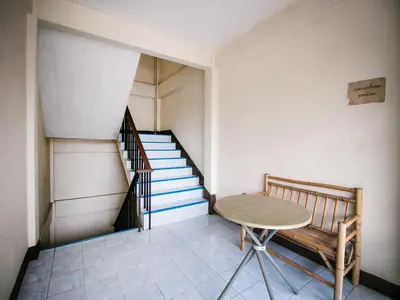 a room with a table and a staircase at OYO 525 MRT Phetkasem 48 -1 Place in Bangkok
