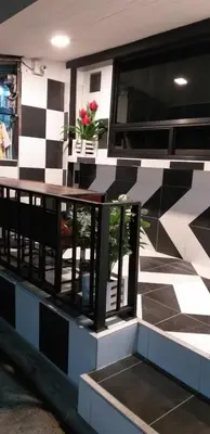 a building with a table with flowers on it at Benjamas hostels in Bangkok