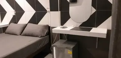 a small room with a sink and a bed at Benjamas hostels in Bangkok