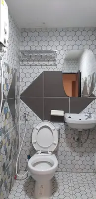 a bathroom with a toilet and a sink at Benjamas hostels in Bangkok