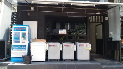 a row of refrigerators sitting outside of a building at Benjamas hostels in Bangkok