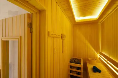 a bathroom with yellow walls and a ceiling with a light at Somerset Rama 9 Bangkok in Bangkok