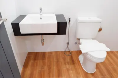 a bathroom with a white toilet and a sink at J & L Residence and Spa in Ban Khlong Khwang Klang