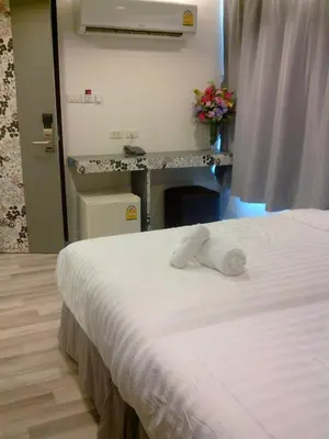 a hotel room with a bed and a sink at Nantra Ploenchit hotel in Bangkok
