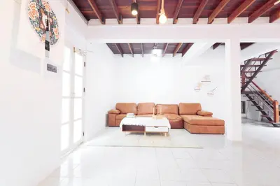 a living room with a couch and a table at Ratchada Retreat Boutique Villa 1 in Bangkok