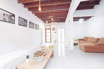 a living room with a couch and a table at Ratchada Retreat Boutique Villa 1 in Bangkok