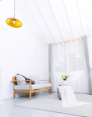 a white living room with a bench and a window at Ratchada Retreat Boutique Villa 1 in Bangkok