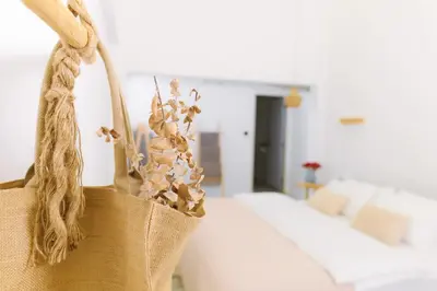 a tote bag with a couch in a living room at Ratchada Retreat Boutique Villa 1 in Bangkok