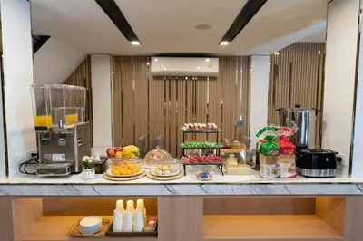a buffet of food on a counter in a room at Malades House in Bangkok