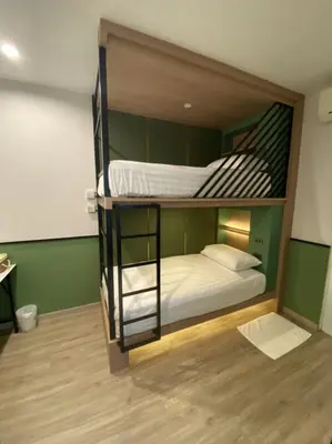 a couple of bunk beds in a room at Malades House in Bangkok