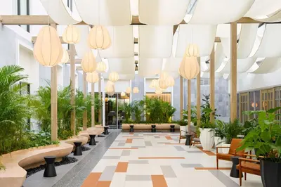 a lobby with potted plants and chandeliers at ASAI Bangkok Chinatown in Bangkok