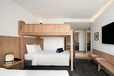 a bedroom with a bunk bed and a tv at ASAI Bangkok Chinatown in Bangkok