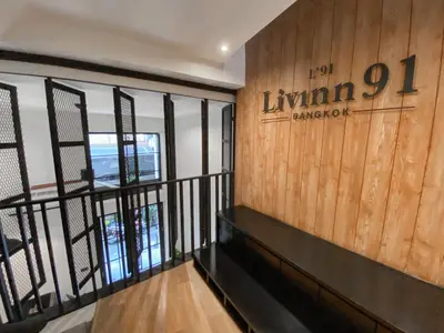 a lobby with a sign that reads lynn champion at Livinn91 Hotel in Bangkok