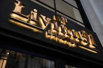 a sign on the side of a building at Livinn91 Hotel in Bangkok