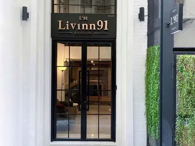 a front door of a building with a sign on it at Livinn91 Hotel in Bangkok