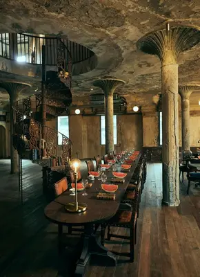 a long dining room with a long table and chairs at The Mustang Blu in Bangkok