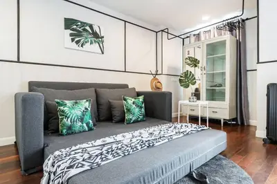 a bedroom with a large bed with green and white pillows at MIQ Asoke202 Pool Villa - Asoke BTS 16 Pax in Bangkok