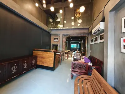 a person sitting at a table in a restaurant at Baan Wualamphong บ้านวัวลำพอง in Bangkok