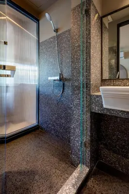 a bathroom with a shower and a sink at The Spades Private Residence in Bangkok