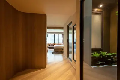 a hallway with a door leading to a living room at The Spades Private Residence in Bangkok