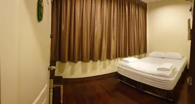 a small room with a bed and a window at Papermoon Guesthouse in Bangkok