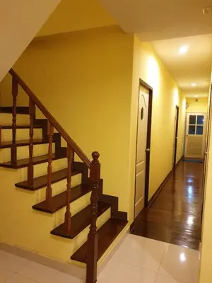 a staircase in a house with a hallway at Papermoon Guesthouse in Bangkok