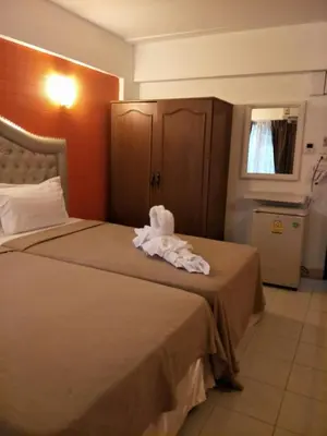 a hotel room with a bed with a towel on it at @42 Residence in Bangkok