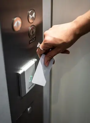 a person holding a piece of paper in an elevator at Siamplaengna Residence in Bangkok