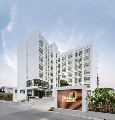 a white building with a sign in front of it at Siamplaengna Residence in Bangkok