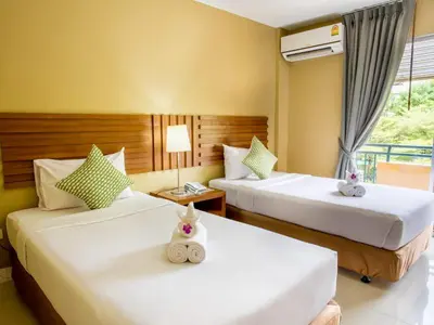 a hotel room with two beds with stuffed animals on them at Paholyothin Park Place in Bangkok
