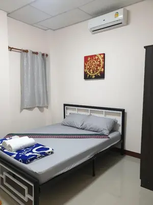 a bedroom with a bed in a room at TP home in Bangkok