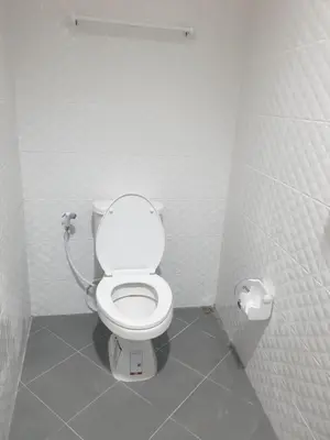 a bathroom with a white toilet in a stall at TP home in Bangkok