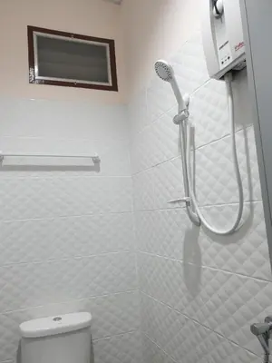 a bathroom with a shower and a toilet at TP home in Bangkok