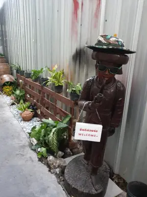 a statue of a man wearing a hat and sunglasses at TP home in Bangkok