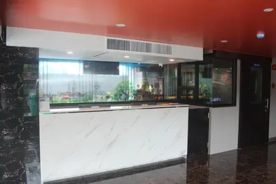 a lobby with a large white counter in a building at H-District Boutique Poshotel in Bangkok