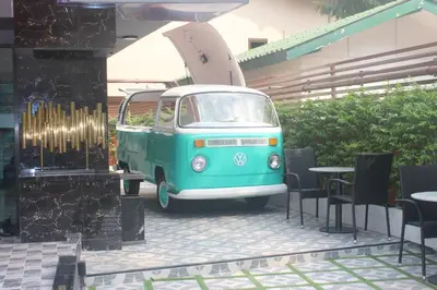 a green and white van with a surfboard on it at H-District Boutique Poshotel in Bangkok
