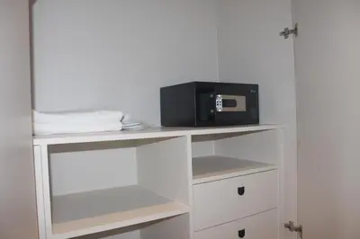 a microwave sitting on top of a white shelf at H-District Boutique Poshotel in Bangkok