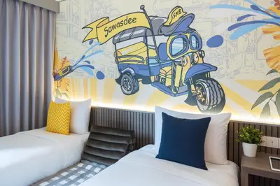 a bedroom with two beds and a mural of a motorcycle at lyf Sukhumvit 8 Bangkok in Bangkok