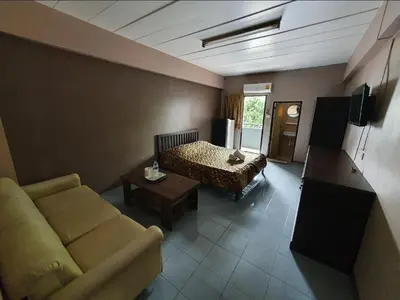 a living room with a couch and a bed at Million Mansion in Bangkok